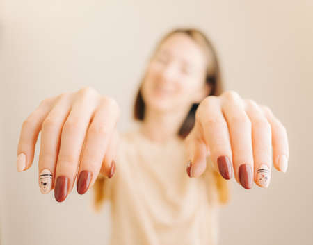 Portrait smiling young woman with beautiful stylish manicure and modern nail design.の写真素材