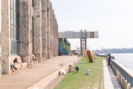Saint-Petersburg, Russia, 03 September 2020: Public art space Sevkabel Port. Embankment with resting and walking people, and a view of the Neva River.のeditorial素材