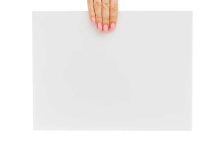In female hand, a blank white poster for mock up.の写真素材