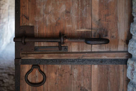 An old door with a rusty iron lock.の写真素材