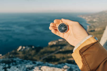 Traveler in the mountains uses a compass.の写真素材