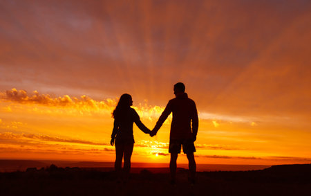 Romantic evening for a couple in love. Silhouette unrecognizable happy man and woman.の写真素材