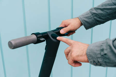Man turns on the electric scooter to go.の写真素材