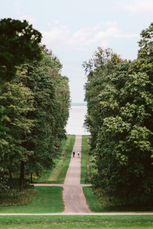 Trail with a couple on bicycles and the Gulf of Finland in park.の写真素材