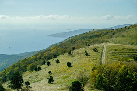 Mountain and sea view with ships.の写真素材