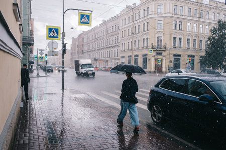 City crossroads with people and cars walking. City during the rain.