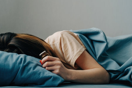 Young woman in bed with antidepressant pills in her hands. The stripes cover the models face.