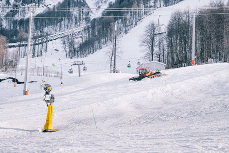 Red modern snowcat ratrack with snowplow snow grooming machine preparing ski slope piste hillalpine skiing winter resort Rosa Khutor.のeditorial素材