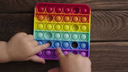 The child plays with a popular toy pop it.の写真素材