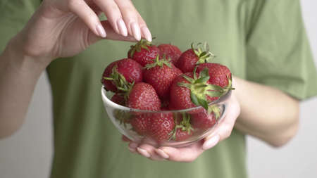 Woman takes strawberriesの写真素材