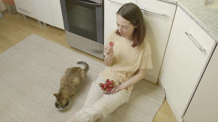 Woman and cat eatの写真素材