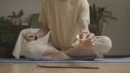 Woman sets fire to an aroma stick.の写真素材