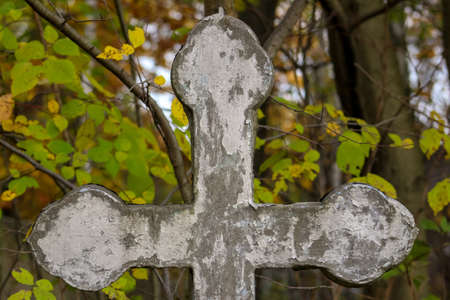 Old shabby grave cross close up. autumn cemetery. Graveyard backgroundの写真素材