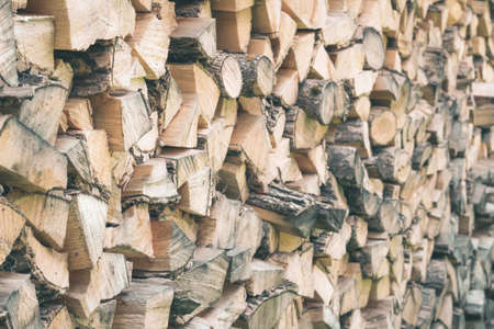 Environmentally friendly fuel. Firewood for a rustic stove. Wood texture. Rustic background Ecologicaly clean fuel. Firewood is laid wallの写真素材