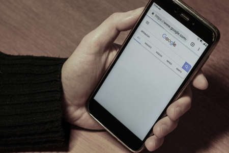 St. Petersburg, Russia, November 24 2018. Amazon in the Google search bar. close up hand with smartphoneのeditorial素材