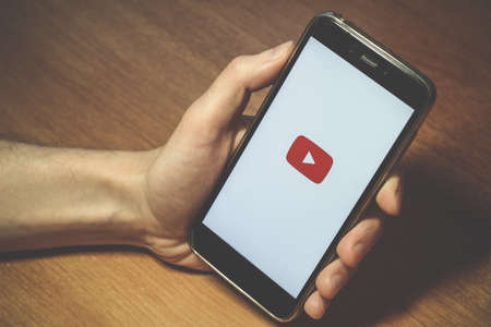 St. Petersburg, Russia, November 24 2018. Red button, emblem, youtube symbol on the smartphone screenのeditorial素材