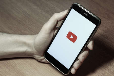 St. Petersburg, Russia, November 24 2018. Red button of the YouTube mobile application on the smartphone screenのeditorial素材