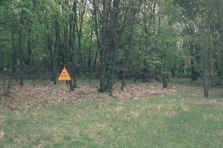 Red-yellow radiation sign on a lawn. Exclusion Zone. Chernobyl, Pripyat