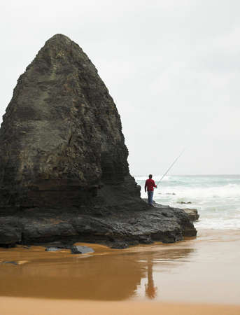 Man fishing at the beachの写真素材