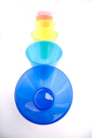 Colourfull plastic cups in a row, bright and cheery.の写真素材