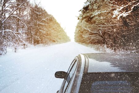 Car in winter in the forest in a snow on a white snowy surfaceの写真素材