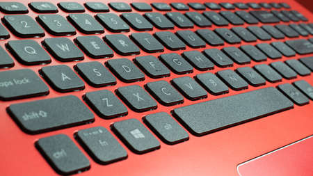 black qwerty keyboard from red laptopの写真素材