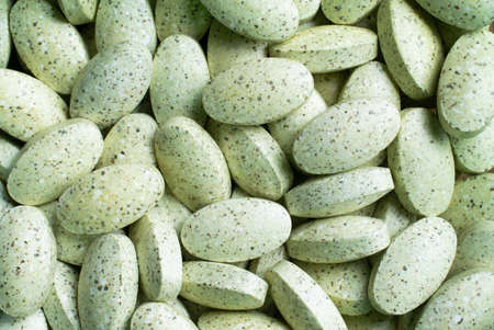 macro photo on a tapete of natural supplement pills from dried vegetables and fruitsの写真素材