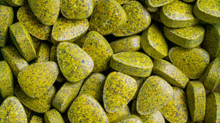 macro photo on a tapete of natural supplement pills from dried vegetables and fruitsの写真素材