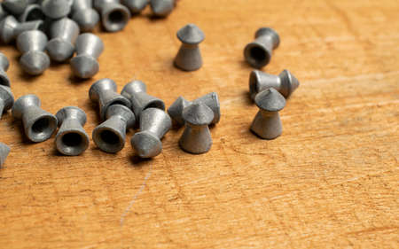 lead bullets on the background of brown boards. lead shot for air rifle. air rifle missiles. air rifle bullets.の写真素材