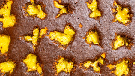 brown yellow wallpaper with cocoa sponge cakeの写真素材