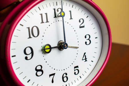Mechanical hand clock white dial. Spring alarm clock.の写真素材