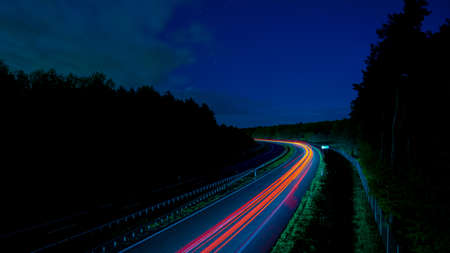 Night road lights. Lights of moving cars at night. long exposure
