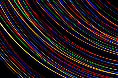 Luminous multicolored wavy lines on a black background