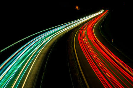 Night road lights. Lights of moving cars at night. long exposure red, blue, green