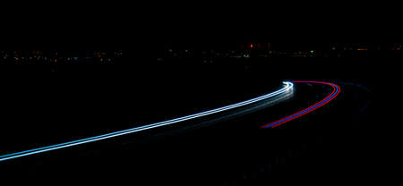 Night road lights. Lights of moving cars at night. long exposure red, blue, green