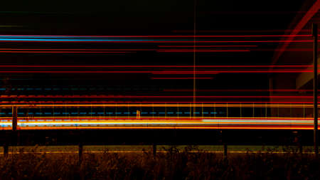 Night road lights. Lights of moving cars at night. long exposure red, blue, green
