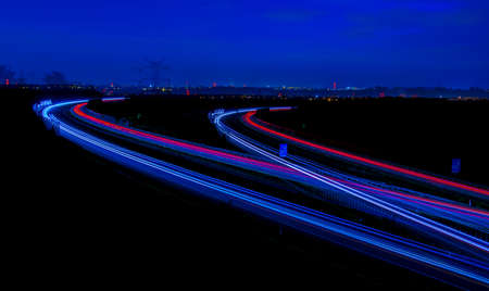 Night road lights. Lights of moving cars at night. long exposure red, blue, green