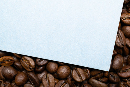 White paper sheet on the background of coffee beans. Label for your individual text.の写真素材