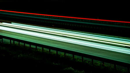 Night road lights. Lights of moving cars at night. long exposure red, blue, green