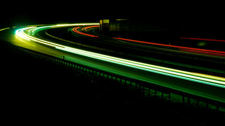 Night road lights. Lights of moving cars at night. long exposure red, blue, green