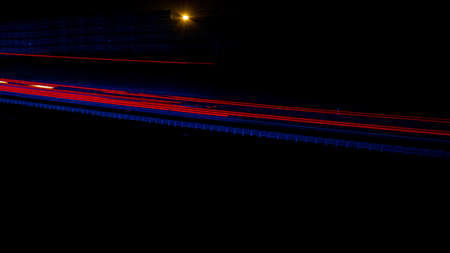 Night road lights. Lights of moving cars at night. long exposure red, blue, green