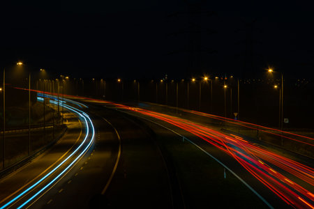 Night road lights. Lights of moving cars at night. long exposure red, blue, orange, multicolored