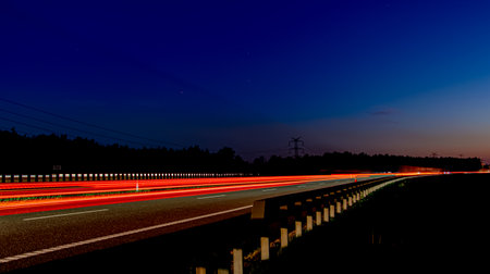 Night road lights. Lights of moving cars at night. long exposure red, blue, orange