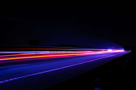Night road lights. Lights of moving cars at night. long exposure red, blue, greenの写真素材