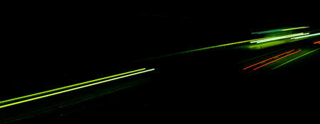 Night road lights. Lights of moving cars at night. long exposure red, blue, green, orange.