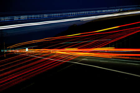 Night road lights. Lights of moving cars at night. long exposure red, blue, green, orange.