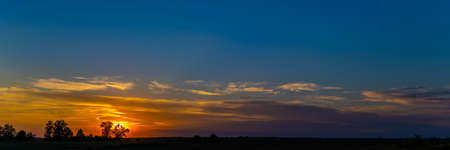 sunset panorama. sunset over a forest in Polandの写真素材