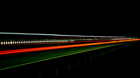 Night road lights. Lights of moving cars at night. long exposure red, blue, green