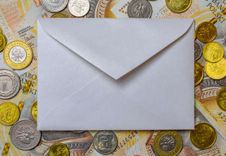 white envelope, blank note on money background, for finance and inflationの写真素材