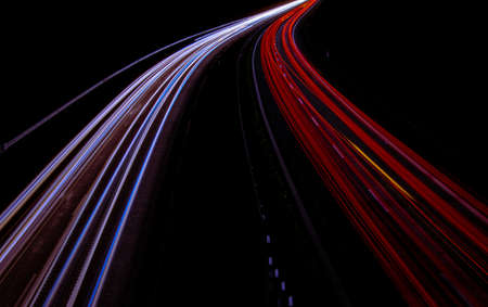 Night road lights. Lights of moving cars at night. long exposure red, blue, green, orange.の写真素材